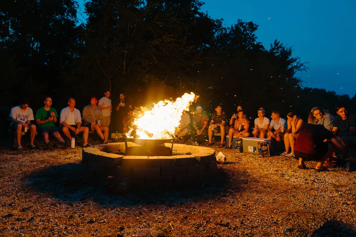 The Taiv team around a campfire at night